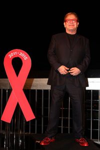 Elton John, World Aids Day; Substance, Circular Quay, Sydney (2011). Photograph by Eva Rinaldi Celebrity and Live Music Photographer. Image via Wikimedia Commons.