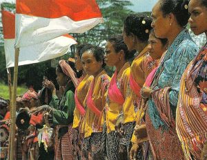 "The Timorese with their national flag, red and white," in East Timor in Pictures (1984). Image via the Department of Foreign Affairs, Republic of Indonesia.