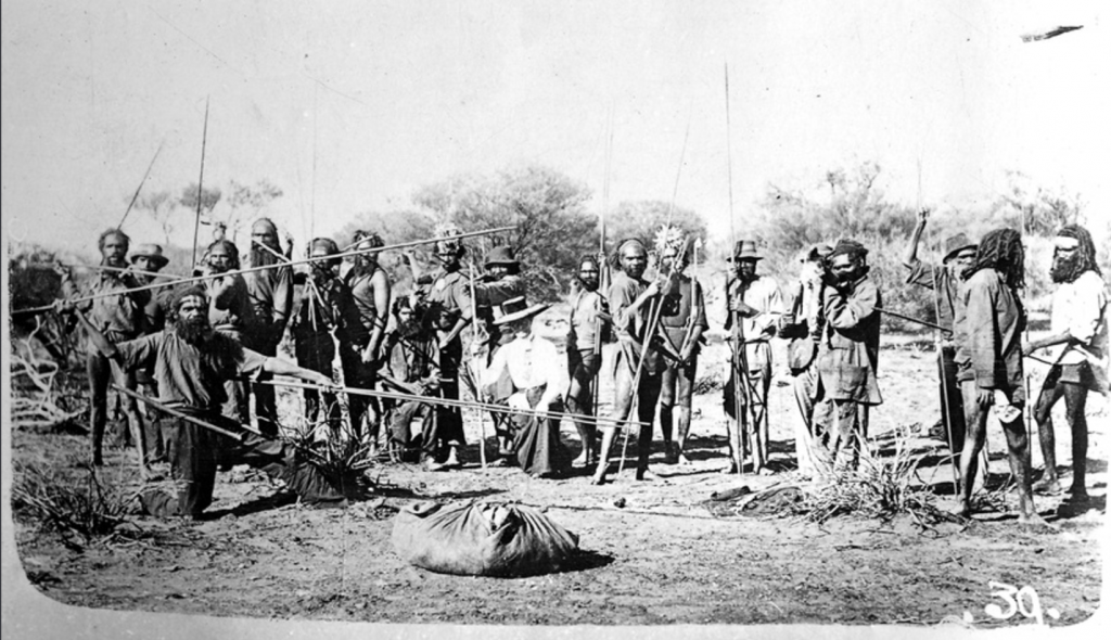 "Daisy Bates with Aboriginal warriors" (1921), photographer unknown. Image via State Library of South Australia.