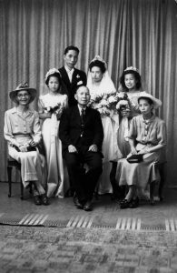 Wedding of Philip and Edith Leong, including bridesmaids and family (1944). Image via John Oxley Library, State Library of Queensland.