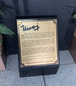 Picture of a commemorative plaque on the ground.